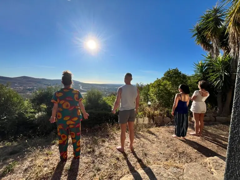 mixed group of adults sun salutation at psilocybin mushroom retreat