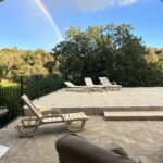 rainbow in a blue sky with a view of nature, terrace in algarve portugal