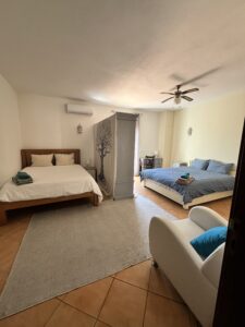 two double beds with room divider at a psilocybin mushroom retreat