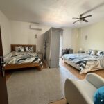 two king beds with a divider between; shared bedroom at a psilocybin retreat with Intuitive Kasham