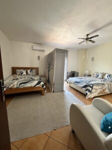 two king beds with a divider between; shared bedroom at a psilocybin retreat with Intuitive Kasham